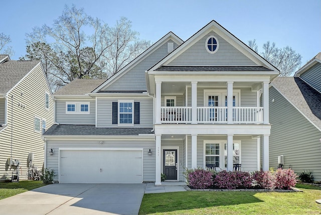 view of front of home featuring a front lawn, concrete driveway, covered porch, a balcony, and a garage