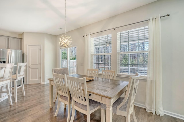 dining room with baseboards and light wood-style floors