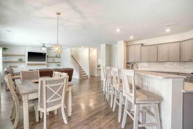 dining area with visible vents, recessed lighting, stairs, and wood finished floors