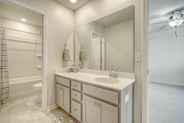 bathroom featuring baseboards, ceiling fan, toilet, vanity, and shower / bathtub combination with curtain