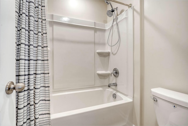 bathroom with shower / bath combination with curtain and toilet