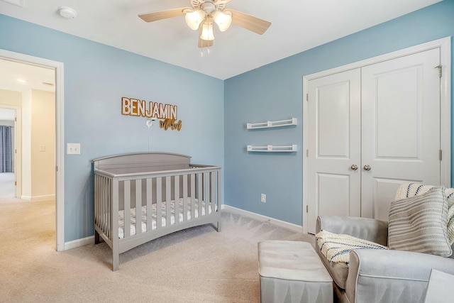 bedroom with carpet flooring, baseboards, a closet, and ceiling fan