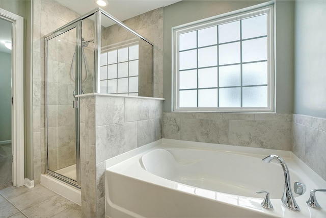 full bath with a shower stall and a garden tub