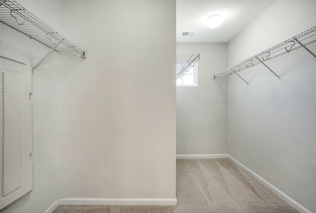 spacious closet with light carpet and visible vents