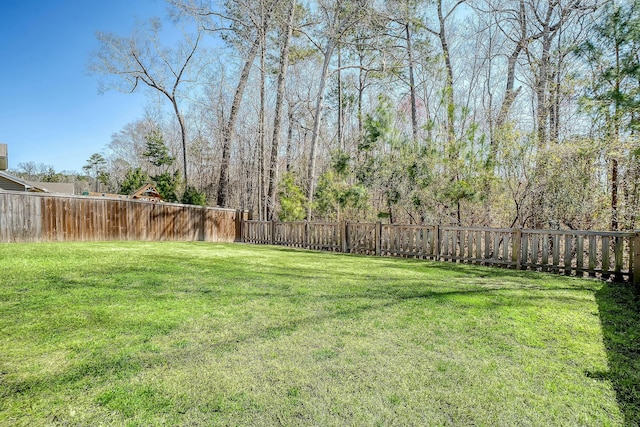 view of yard with a fenced backyard