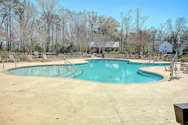 pool featuring a patio area and fence