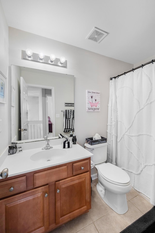 bathroom featuring visible vents, vanity, toilet, and tile patterned floors