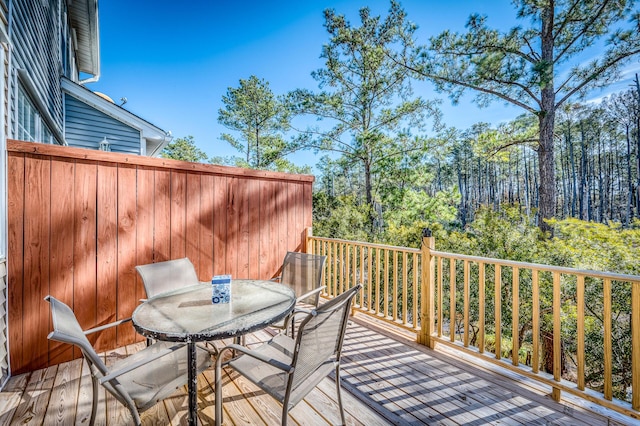 wooden terrace with outdoor dining space