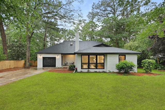 120 Live Oak Rd, Summerville, SC 29485 - rear view of property featuring driveway, fence, a yard, a garage, and brick siding