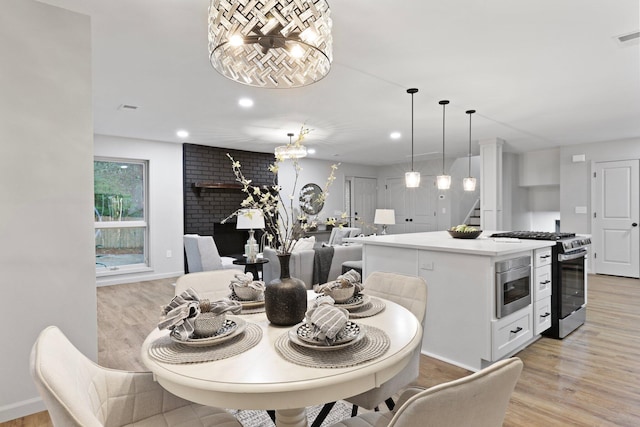 120 Live Oak Rd, Summerville, SC 29485 - dining area with light wood finished floors, baseboards, recessed lighting, a notable chandelier, and stairs