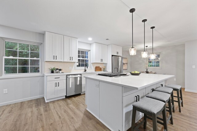 120 Live Oak Rd, Summerville, SC 29485 - kitchen with white cabinets, stainless steel appliances, light wood finished floors, and a breakfast bar area