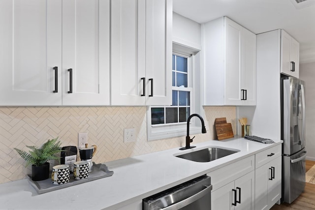 120 Live Oak Rd, Summerville, SC 29485 - kitchen with white cabinets, stainless steel appliances, a sink, tasteful backsplash, and wood finished floors