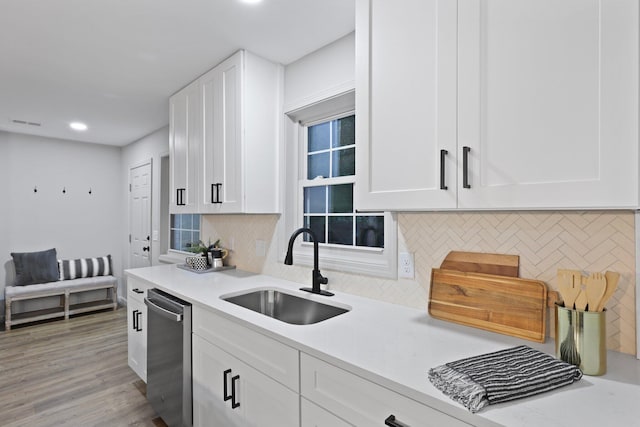 120 Live Oak Rd, Summerville, SC 29485 - kitchen featuring light countertops, stainless steel dishwasher, a sink, tasteful backsplash, and white cabinetry