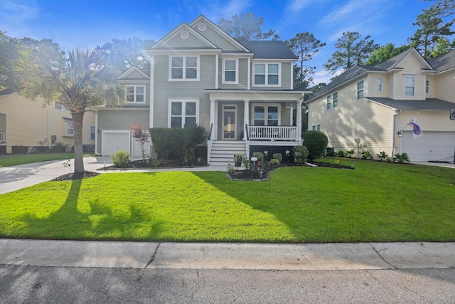 view of front of property with a garage, a front yard, and covered porch