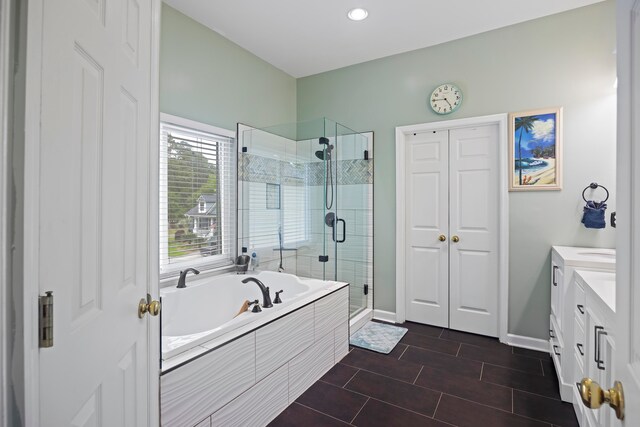 bathroom featuring vanity and separate shower and tub