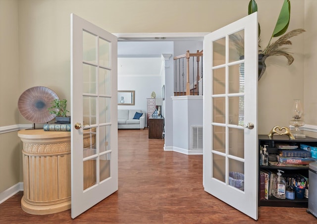 corridor with hardwood / wood-style flooring and french doors