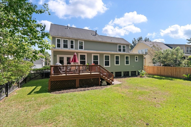 back of house featuring french doors, a deck, and a lawn