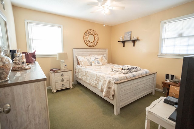 bedroom with ceiling fan and dark colored carpet