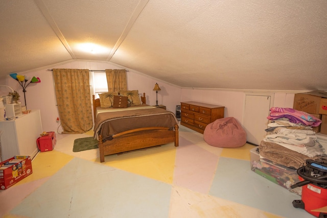 bedroom featuring vaulted ceiling and a textured ceiling