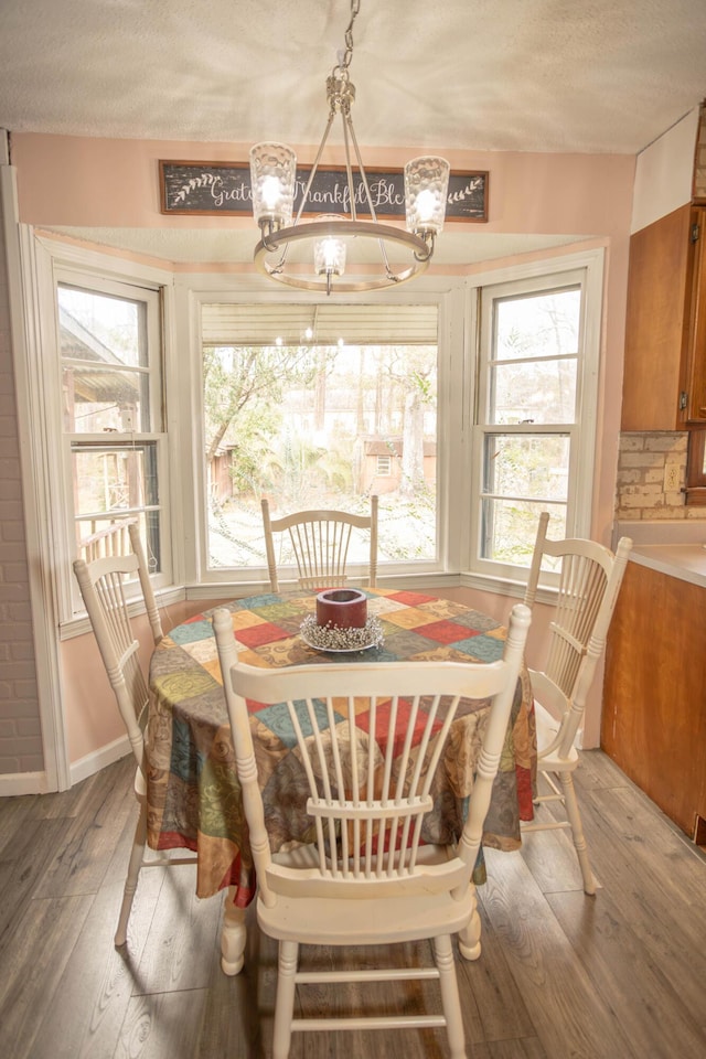 dining room with hardwood / wood-style floors and a textured ceiling