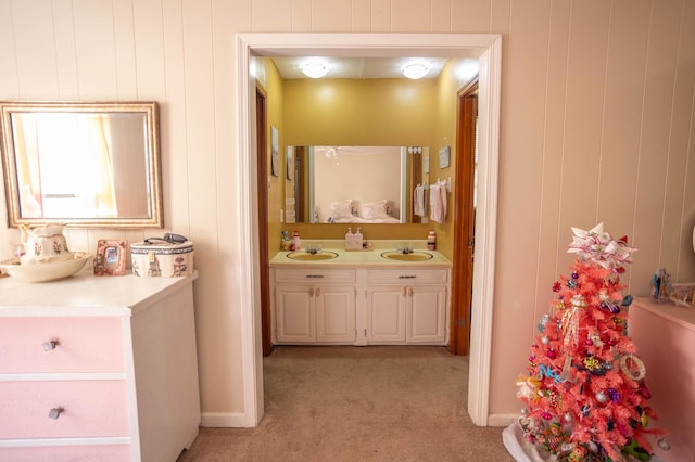 bathroom with vanity and wood walls