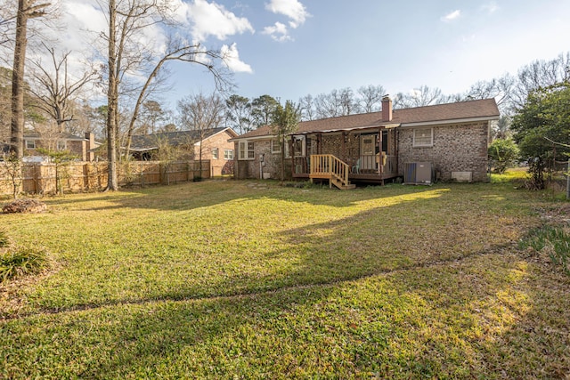 view of yard featuring a wooden deck and cooling unit