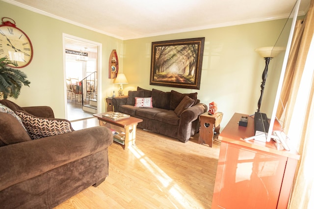 living room with crown molding and light wood-type flooring