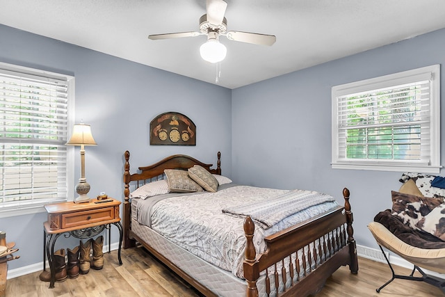 bedroom featuring baseboards, a ceiling fan, and wood finished floors