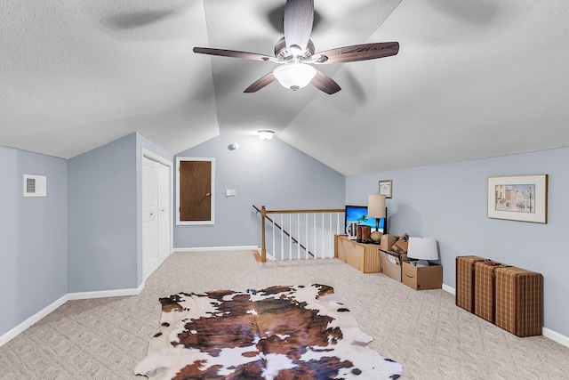 additional living space with visible vents, a ceiling fan, lofted ceiling, baseboards, and carpet flooring