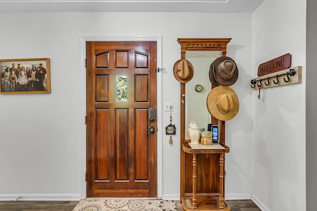 entrance foyer featuring baseboards and wood finished floors