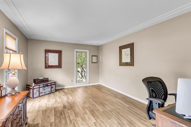 office featuring baseboards and light wood finished floors