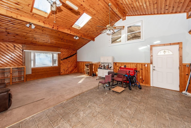 bonus room with carpet, ceiling fan, vaulted ceiling with skylight, and wooden ceiling