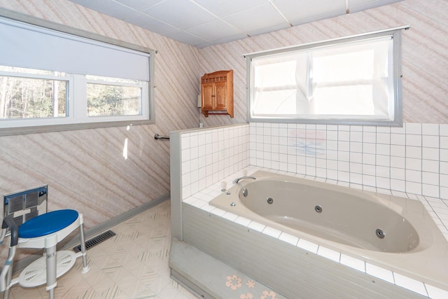 bathroom featuring tile patterned floors and tiled tub