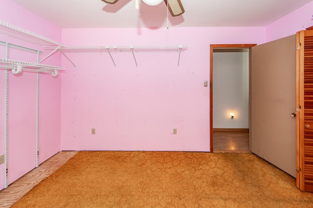 interior space featuring carpet flooring and ceiling fan