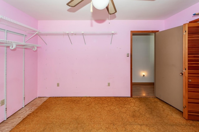 interior space with carpet flooring and ceiling fan