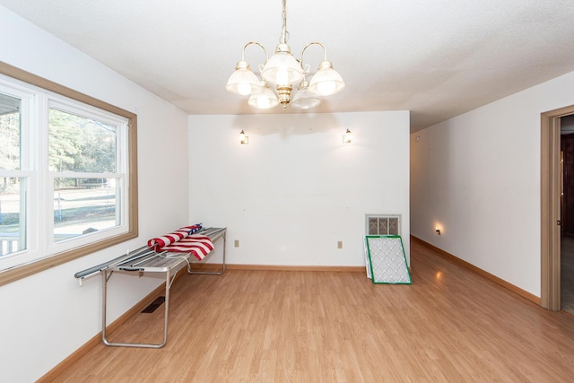 sitting room featuring light hardwood / wood-style floors and an inviting chandelier