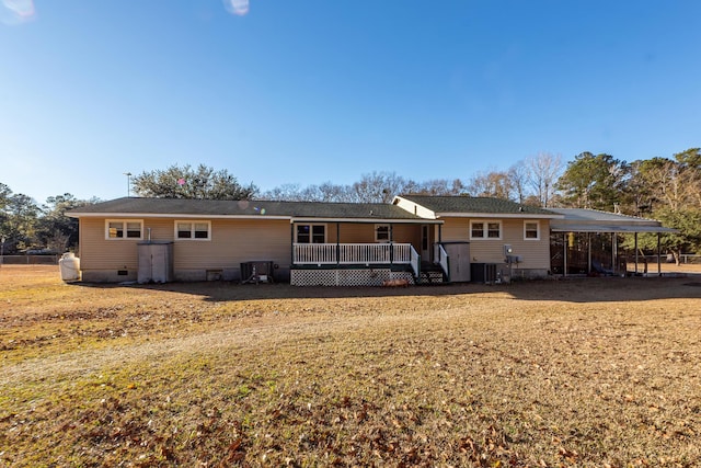 rear view of property featuring a carport and cooling unit