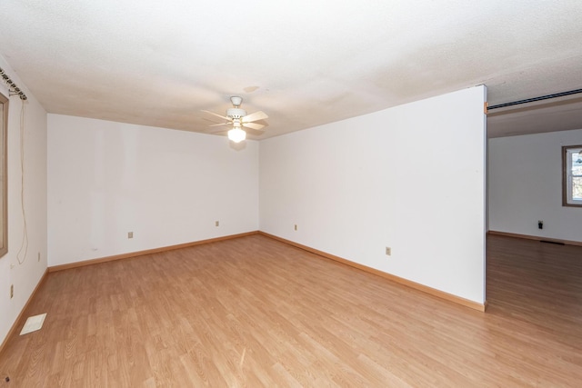 spare room featuring ceiling fan, a textured ceiling, and light hardwood / wood-style flooring