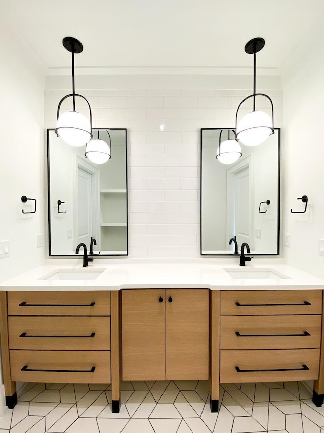 full bathroom featuring double vanity, a sink, and crown molding