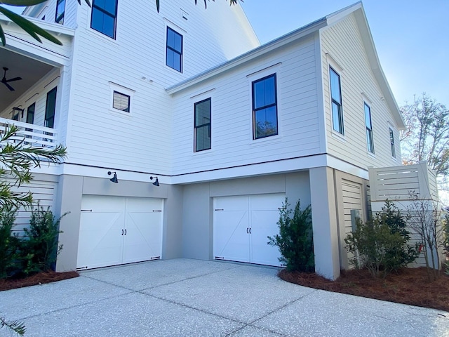 view of property exterior featuring an attached garage, driveway, and stucco siding