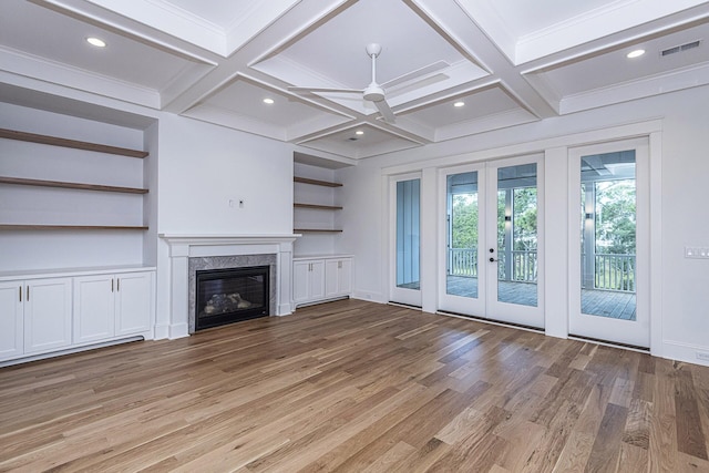 unfurnished living room featuring french doors, a ceiling fan, light wood-type flooring, visible vents, and coffered ceiling
