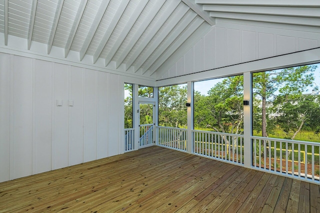 unfurnished sunroom with plenty of natural light and beam ceiling