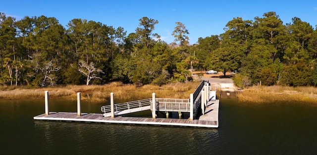 view of dock featuring a water view and a wooded view