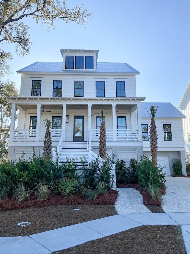 view of front of home with covered porch, ceiling fan, a standing seam roof, metal roof, and concrete driveway
