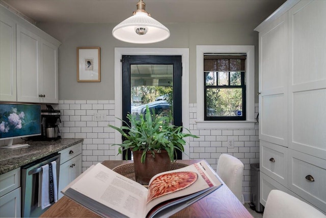 dining space featuring wainscoting and tile walls