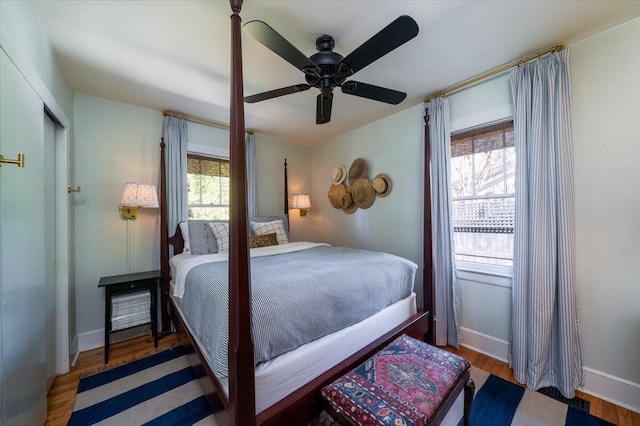 bedroom with wood finished floors, a ceiling fan, and baseboards