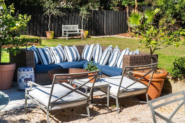 view of patio featuring fence and an outdoor living space