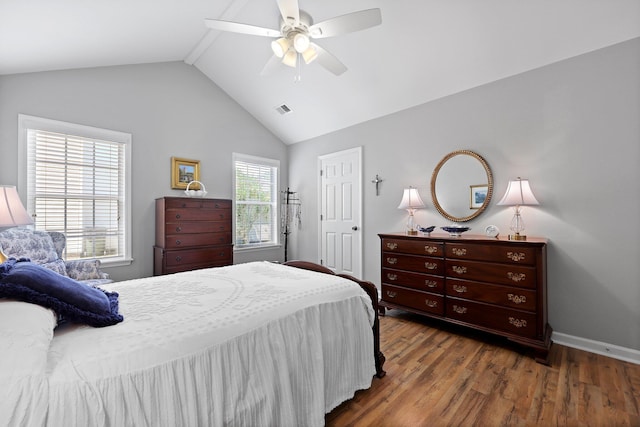 bedroom featuring vaulted ceiling, wood finished floors, ceiling fan, and baseboards
