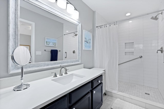 bathroom with a stall shower, vanity, and tile patterned flooring