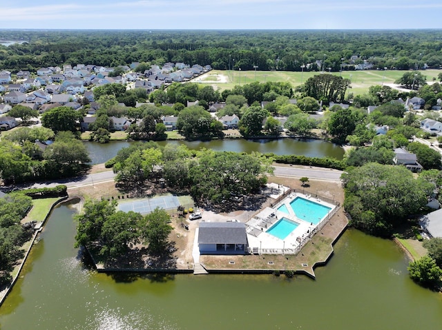 drone / aerial view of a pool and a nearby body of water